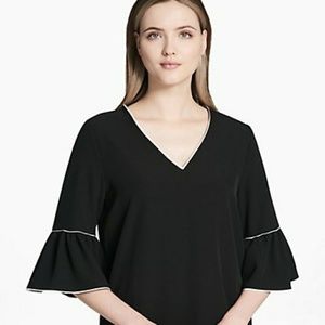 Black Calvin Klein trumpet sleeve top.